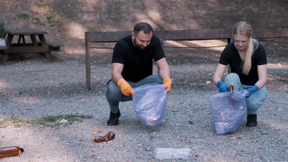 Two Volunteers Collecting Trash in the Community Park As a Weekend Activity