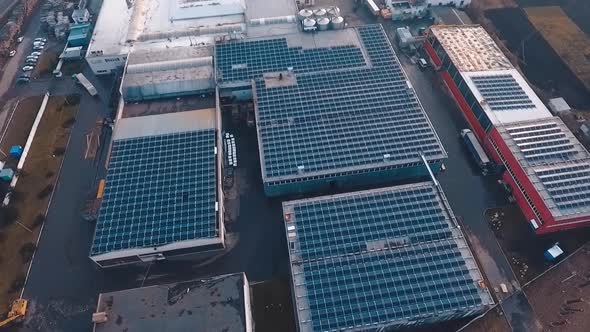 Solar powered factory structure. Aerial view of factory roof with solar panels