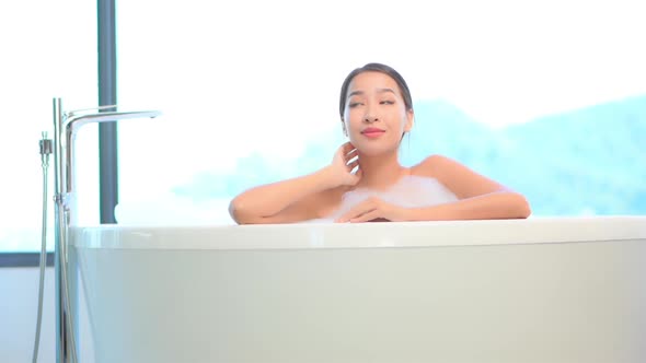 Young asian woman relax in bathtub