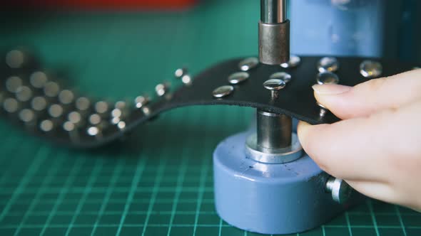 Worker Fixes Silver Holnitens on Stylish Leather Choker