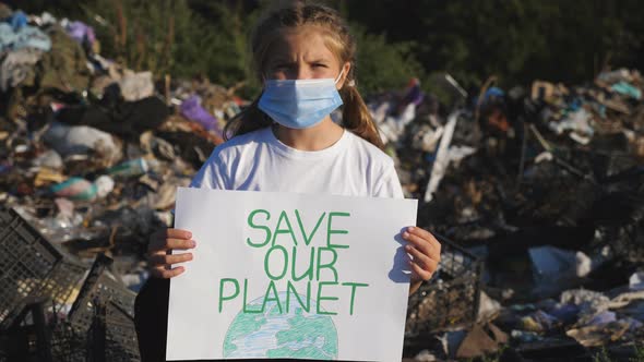 Little Girl in Medical Protective Mask Looks Into Camera Holding in Hands Poster of Environmental