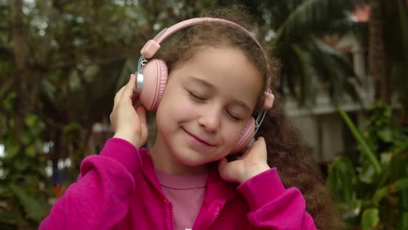 Portrait of Cute Little Child On Relaxing on With Eyes Closed Wearing Headphones