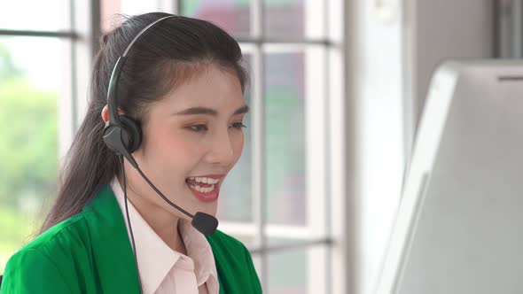 Businesswoman Wearing Headset Working Actively in Office