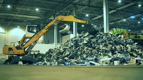 Garbage, Trash, Waste Recycling Factory. Excavator Is Working in the Indoors Junkyard