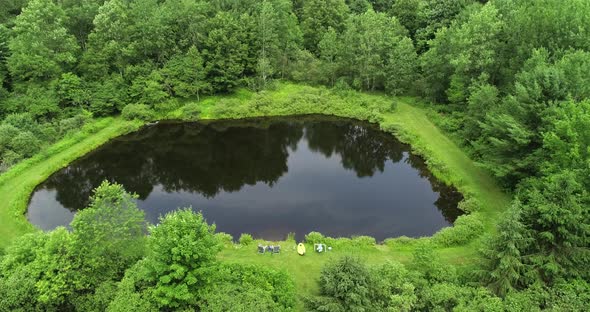 A drone peeps over the top of the trees to see a private fishing pond in the Catskill mountains of N