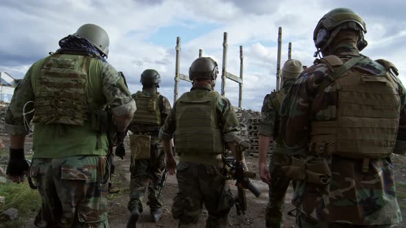 Rear View of Group of Soldiers Walking Together alt