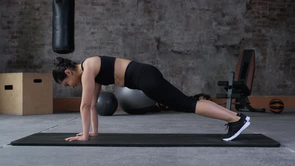 Asian Young active woman doing plank exercise for stronger abs six packs core, self motivation 