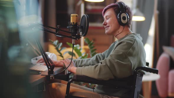 Cheerful Woman on Wheelchair Recording Podcast in Home Studio