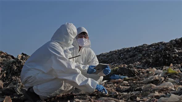 Scientist wearing personal protective equipment (PPE) at landfill site