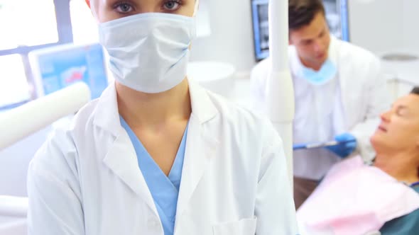 Portrait of dentist standing with arms crossed