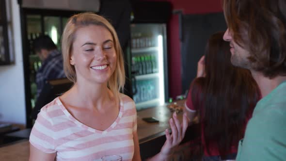 Friends at the bar in a pub having fun