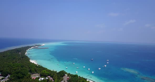 Daytime birds eye island view of a sunshine white sandy paradise beach and blue ocean background in 