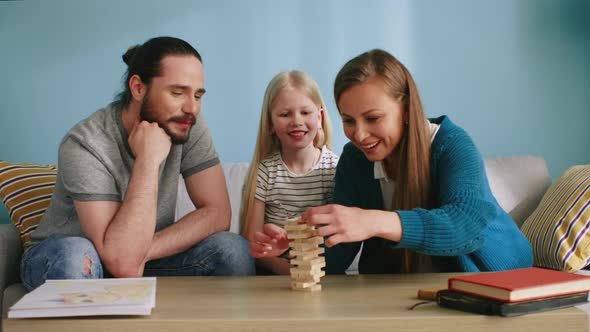 Young Family Has Fun Playing Jenga