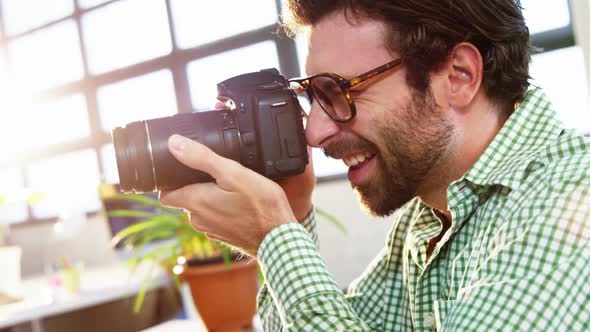 Graphic designer looking at pictures in digital camera