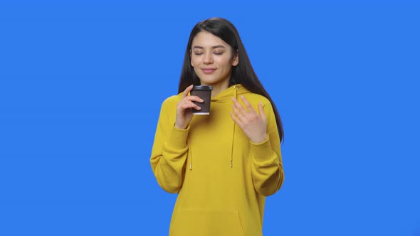 Portrait of Pretty Brunette Enjoying Coffee
