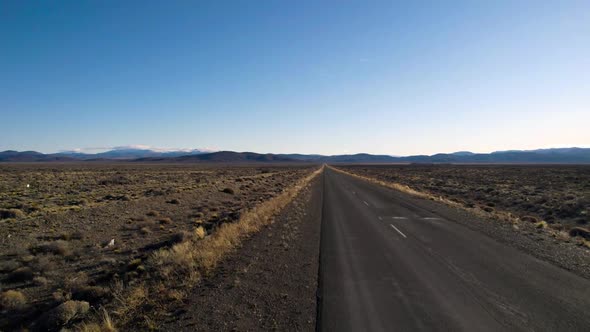 incredible view of mountains and fields on asphalt road