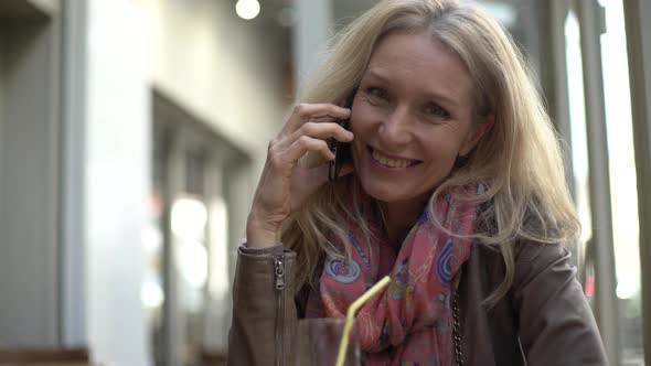 Smiling woman talking on smart phone