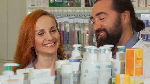 Handsome Bearded Pharmacist Giving His Female Customer Requested Product