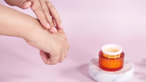 Woman Applying Beauty Cream Onto Skin at Home Top View