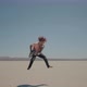 Redhead Barefoot Bloody Musician Plays and Jumps with a Guitar in Desert - VideoHive Item for Sale
