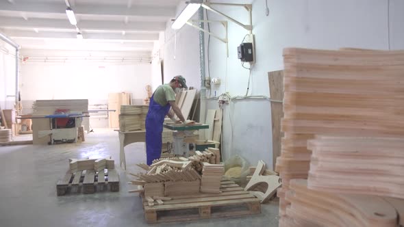 Industrial Carpenter Worker at the Furniture Factory