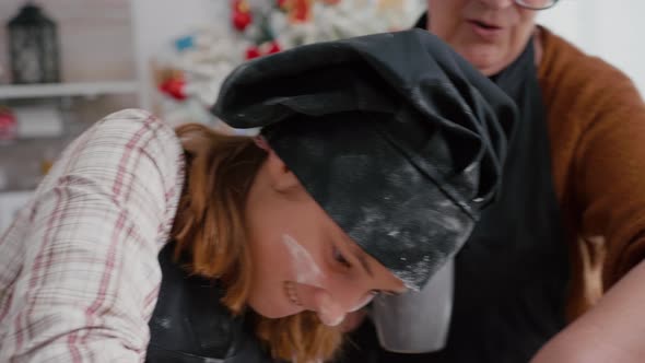 Portrait of Granddaughter with Flour Ingredient on Face Preparing Gingerbread Dessert