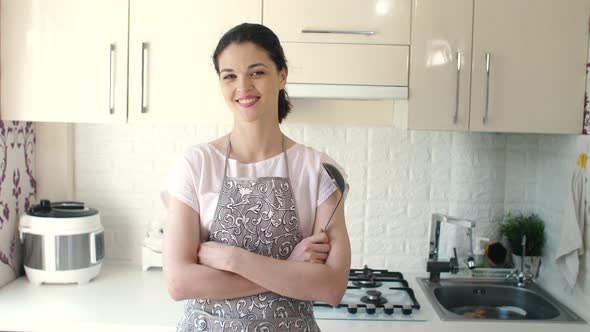 Portrait of Smiling Young Housewife in Modern Kitchen