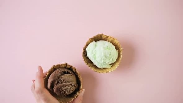 Waffle ice cream bowls with scoops of ice cream on a pink background.