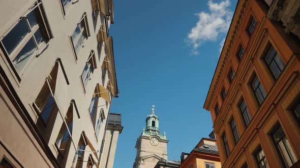 Low Angle Wide Shot To St Nicholas - Storkyrkan Bell Tower in Stockholm. View Through a Narrow