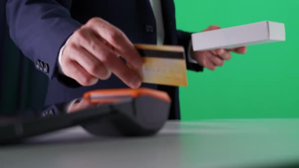 Man in a Suit Makes a Payment with Credit Card NFC Terminal Contactless Payment for Purchases Chroma