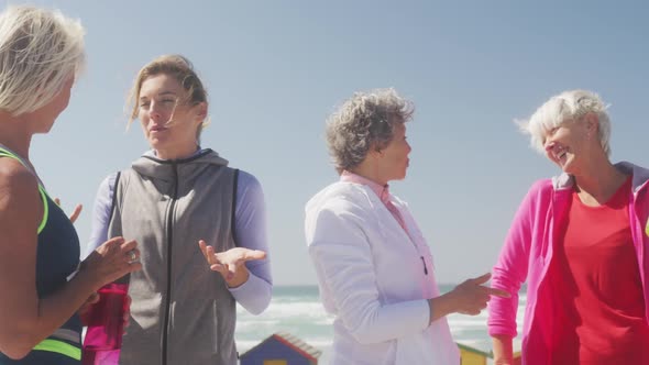 Athletic women discussing on the beach