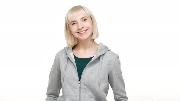 Closeup Portrait of Cute Blond Woman with Bob Haircut in Sweatshirt Looking at Camera Smiling Being