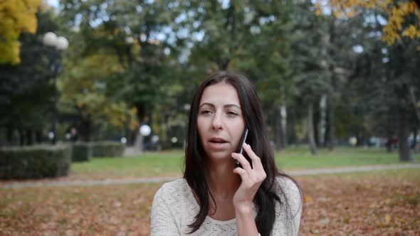 Portrait of a Sad Caucasian Woman Talking on the Phone