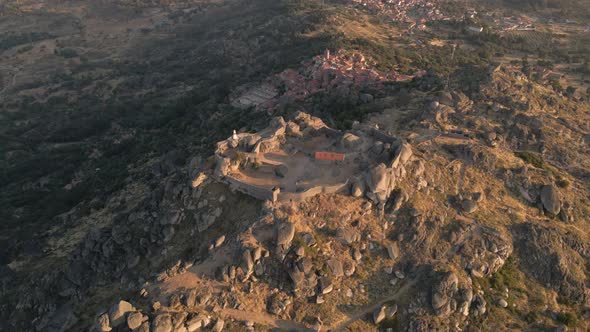 Monsanto castle ruins and ancient village in background at sunrise, Portugal. Aerial approach