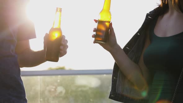 Friends Drinking Beer From Bottles Outdoors