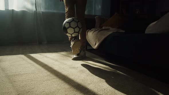 Closeup of Young Sportsman Legs Minting a Soccer Ball Professional Football Player Training in the