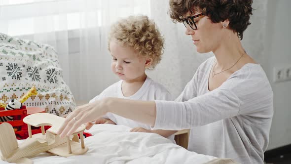 Curly Mother and Toddler Playing Together alt