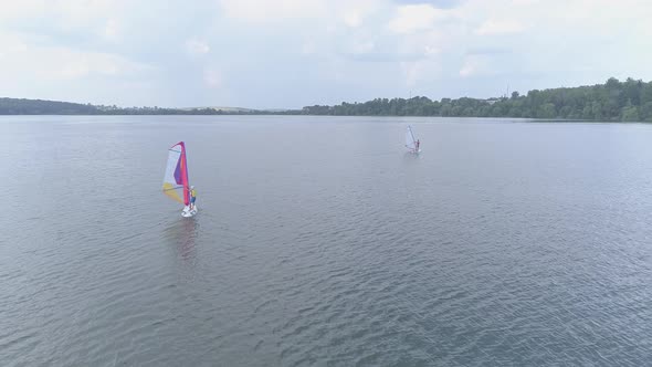 Windsurfers sailing on a lake