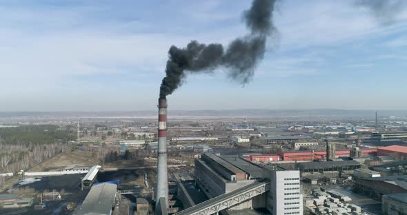 Front View of Coal-fired Plant Smokestack Emits Black Smoke 