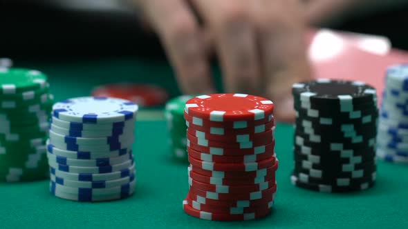 Player Looking at Cards and Putting Chips on Stack, Going All-In, Game Bluff