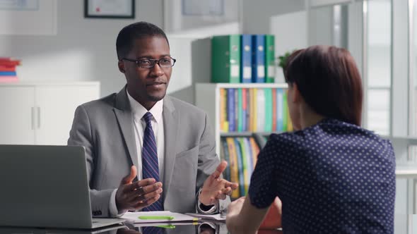 AfricanAmerican Executive Have Job Interview with Female Applicant