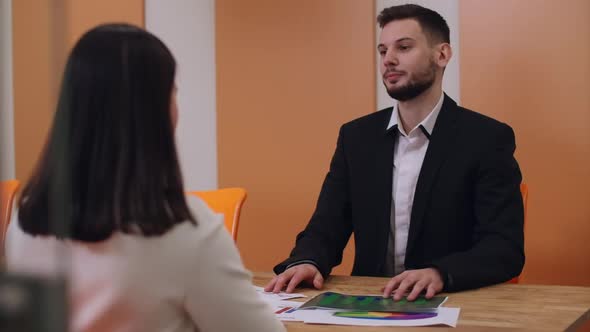 Portrait of Confident Positive Applicant Talking with Interviewer in Business Office