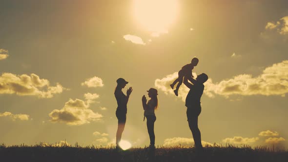 Happy Family Walking in Field on Sunny Day. Concept of Friendly Family.