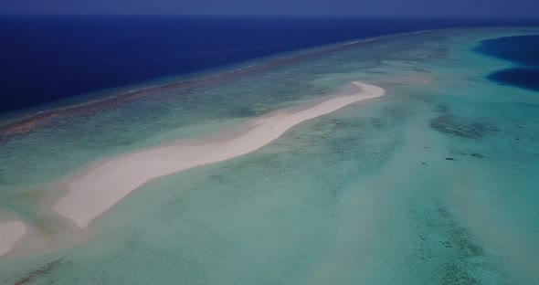 Daytime overhead clean view of a summer white paradise sand beach and turquoise sea background in hi