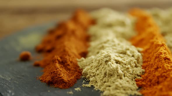 Various type of spice powder on tray 4k