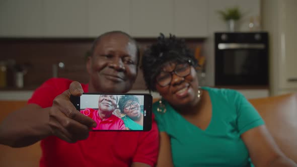 Senior African Couple Making Video Call at Home
