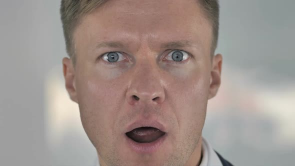 Close Up of Shocked Face of Businessman Wondering