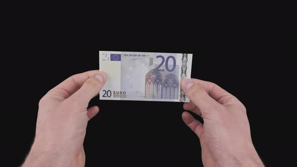 Male Hands Show a Banknote of 20 Euros with Alpha Channel
