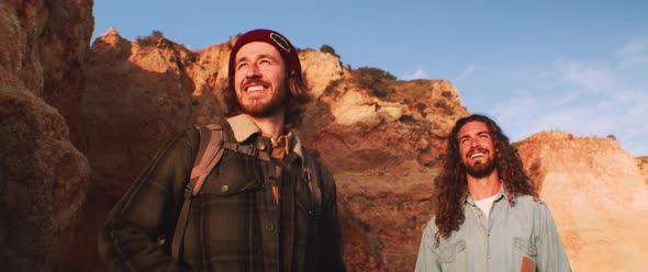 Two friends admiring the nature on a wild beach