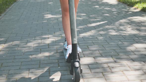 A Girl Rolls Around on City Tiles in the Park